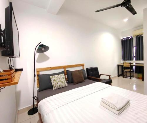 a bedroom with a large bed and a television at Suite Us Guesthouse Kubang Kerian in Kota Bharu