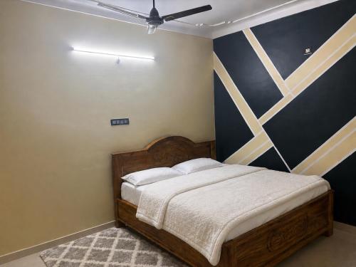 a bedroom with a bed and a ceiling fan at Winter Valley Grand Araku in Araku
