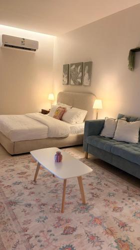 a living room with a bed and a couch at August in Jazan