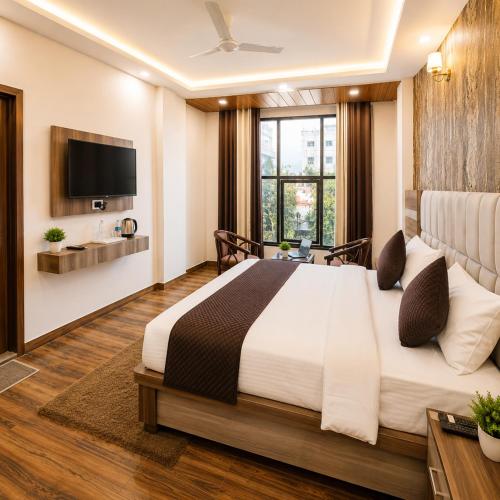a bedroom with a large bed and a television at Hotel Lotus Infinity in Haridwār