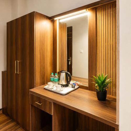 a bathroom with a wooden vanity with a mirror at Hotel Lotus Infinity in Haridwār