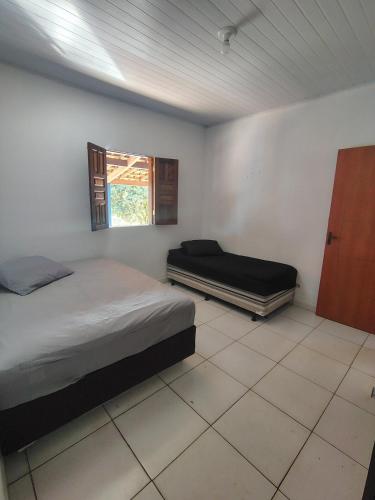 a bedroom with two beds and a window at Vila Azul Casa Completa em Ibicoara in Ibicoara