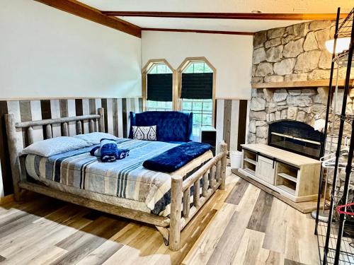 a bedroom with a bed and a stone fireplace at Camp Squid Off The Grid in Benzonia