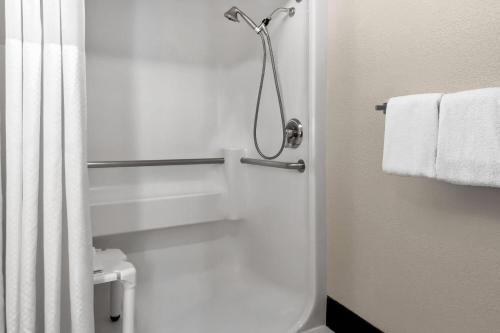a bathroom with a shower with a toilet and towels at Baymont by Wyndham Santa Fe in Santa Fe