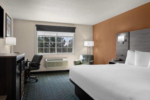 a hotel room with a bed and a window at Baymont by Wyndham Santa Fe in Santa Fe
