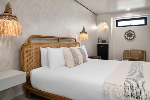 a bedroom with a white bed with white pillows at Bali Hotel Adults Only Isla Verde, a Trademark by Wyndham in San Juan
