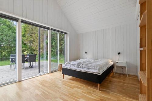a bedroom with a bed and a large window at 8574-Grenaa-Annavej-13 in Gjerrild