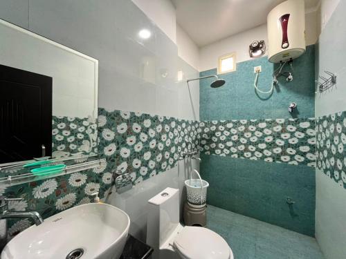a bathroom with a sink and a toilet at Nagarkoti Residency Inn in Pithorāgarh