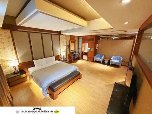 a hotel room with a bed and a living room at Venice Motel in Kaohsiung