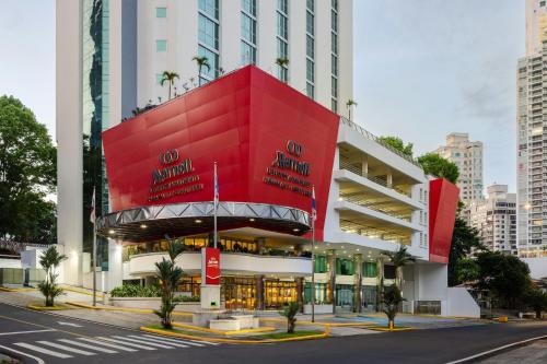 a red building in the middle of a city at Marriott Executive Apartments Panama City, Finisterre in Panama City