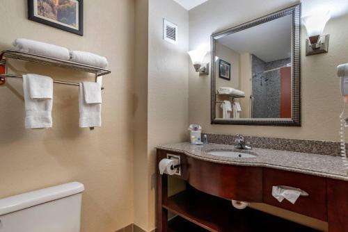 a bathroom with a sink and a mirror at Comfort Inn & Suites Clinton - Jackson West in Clinton