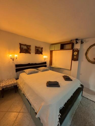 a bedroom with a large bed and a clock on the wall at 'Round the Corner in Piran
