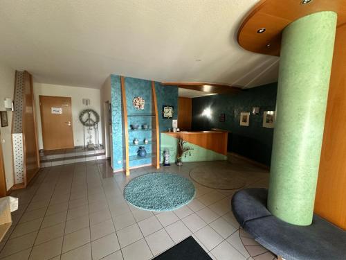 a large room with a lobby with a clock on the wall at Hotel Lachnerhof in Erlangen