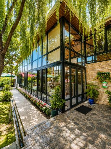a building with windows and plants in front of it at Sheki Secret Garden Boutique Hotel & Guest House in Sheki