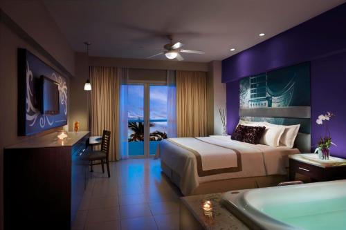 a hotel room with a bed and a bath tub at Hard Rock Hotel Vallarta All Inclusive in Nuevo Vallarta 