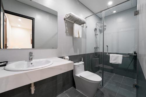 a bathroom with a toilet and a sink and a shower at Gao House in Hanoi