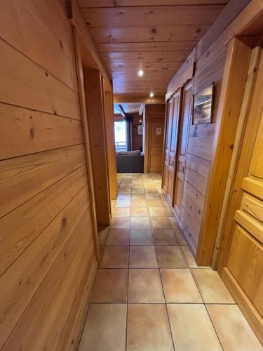 a hallway in a cabin with wood paneling at Appartement Chez Marion in Notre-Dame-de-Bellecombe