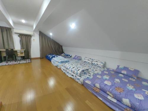 a room with two beds in the middle of it at Stay181 Bintulu in Bintulu