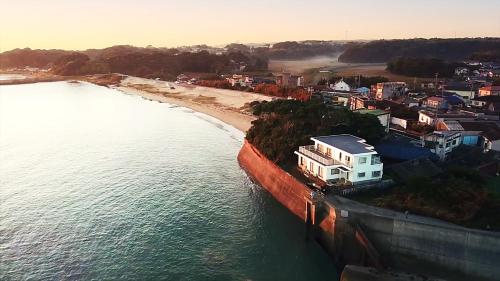 an aerial view of a beach and a house next to the water at Ocean view JUN in Shima