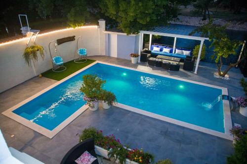 an overhead view of a swimming pool at night at Private Riverside Villa Silvia in Mostar