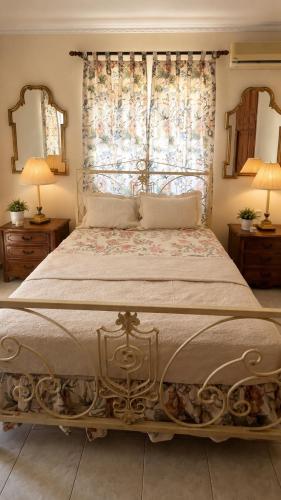 a bedroom with a large bed with a large window at Hemithea Nidri Rooms in Nydri