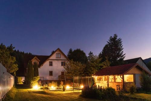 a house at night with lights in the yard at Penzion JAS in Zuberec
