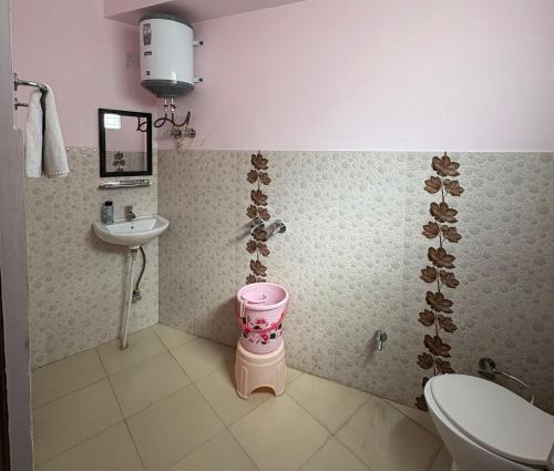 a small bathroom with a sink and a toilet at Pine View Guest House in Nāhan