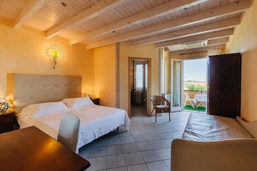a hotel room with a bed and a balcony at Locanda Belvedere in Saludecio