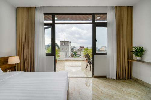 a bedroom with a bed and a view of a balcony at Gao House in Hanoi