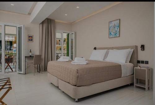 a bedroom with a large bed and a table and chairs at Dimitra Suites in Pythagoreio