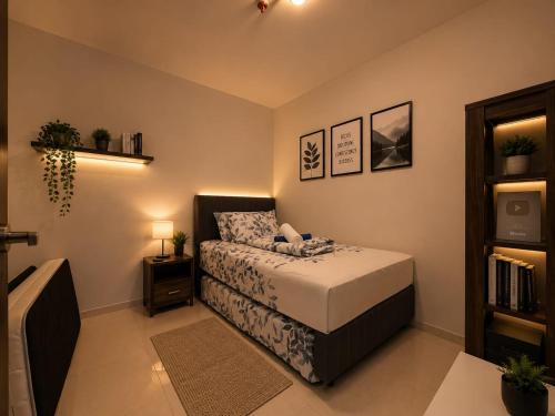 a bedroom with a bed and a book shelf at ETERNITY FORMOSA 2BR BALCONY 76m2 in Jodoh