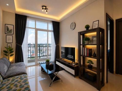 a living room with a large window and a television at ETERNITY FORMOSA 2BR BALCONY 76m2 in Jodoh