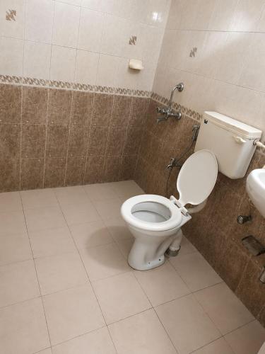 a bathroom with a toilet and a sink at Harmony Vista in Calangute