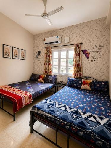 a living room with two beds and a couch at Harmony Vista in Calangute
