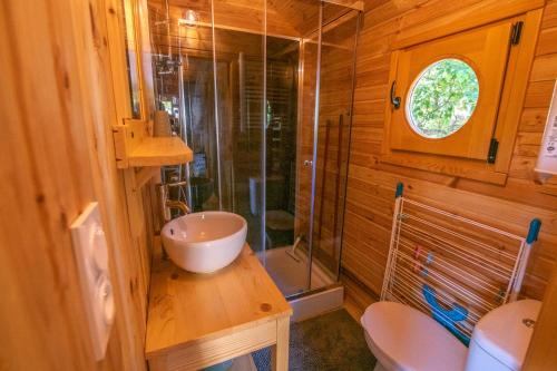 a bathroom with a sink and a shower and a toilet at Camping Onlycamp du Rouergue in Villefranche-de-Rouergue