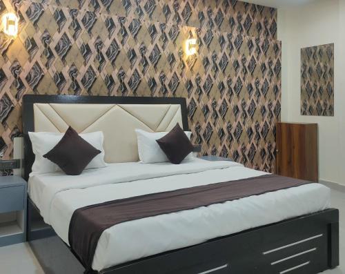 a bedroom with a large bed in a room at Hotel Abhijeet Inn in Raipur
