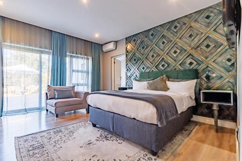 a hotel room with a bed and a chair at Braham Lodge - The Octave 5 in Johannesburg