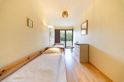 a room with two beds and a desk and a window at Germania-29 in Böhl
