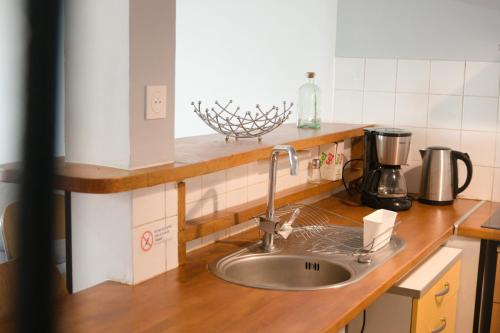 a kitchen counter with a sink in a kitchen at Maison Entière à Cébazat in Cébazat