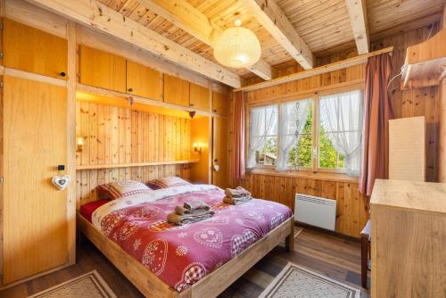 a bedroom with a bed in a wooden room at Darjean - 8 pers - belle vue in Plan Fey