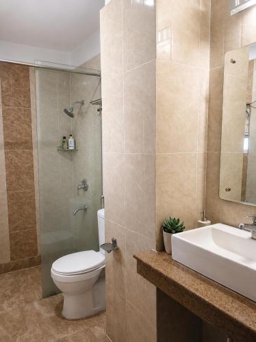 a bathroom with a toilet and a sink and a shower at Hotel Rio Haridwar in Haridwār