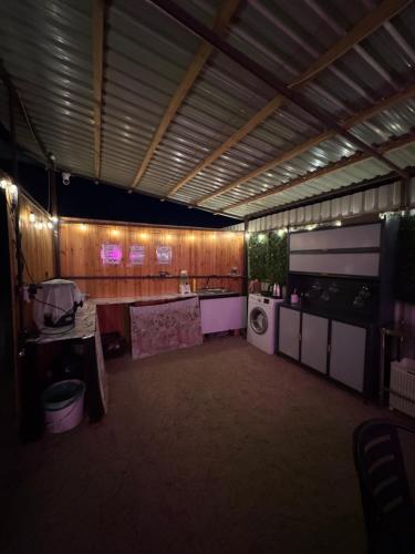 a large room with a kitchen and a washing machine at Issyk-Kul Glamping in Chon-Sary-Oy