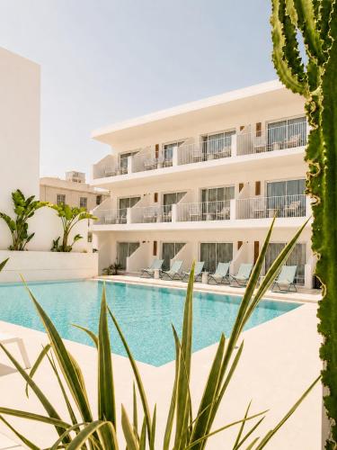 a building with a swimming pool and a cactus at Melitti Lucent in Rethymno