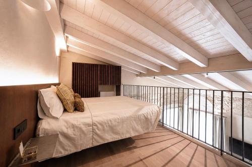 a bedroom with a bed and a balcony at Resort Casa del Monte 1553 in Albenga