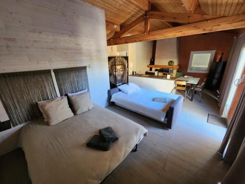 a bedroom with a bed and a couch in a room at Bienvenue chez nous ! in Combrand