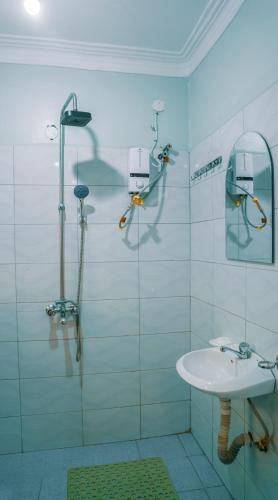 a bathroom with a shower and a sink at Neriah Suites in Kabale