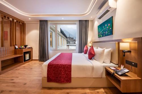 a hotel room with a bed and a window at Lords Inn Katra in Jāmb