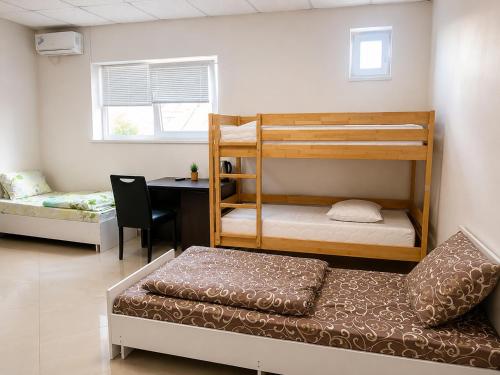 a room with two bunk beds and a desk at PANORAMA HOTEL in Tyachiv