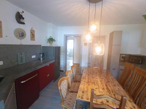 a kitchen with a long wooden table and chairs at EifelRuhe 5 - Platz für bis zu 8 Personen, Hunde willkommen in Schleiden