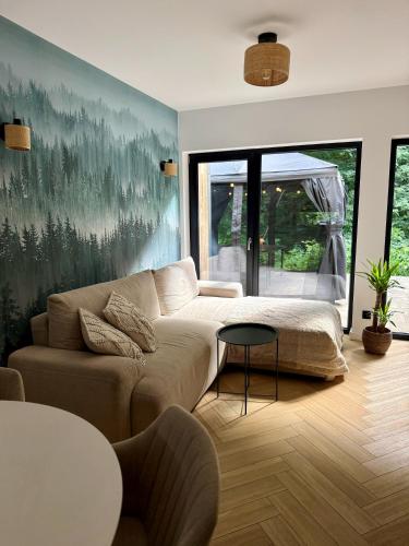 a living room with a couch and a table at Leśny Azyl Rzeszów in Hermanowa